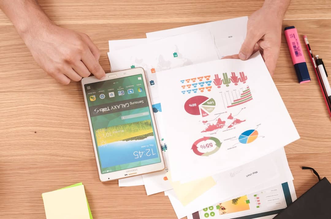 E displaying a person scrutinizing a stack of bills, calculator, and a pie chart with different colors representing various budget categories