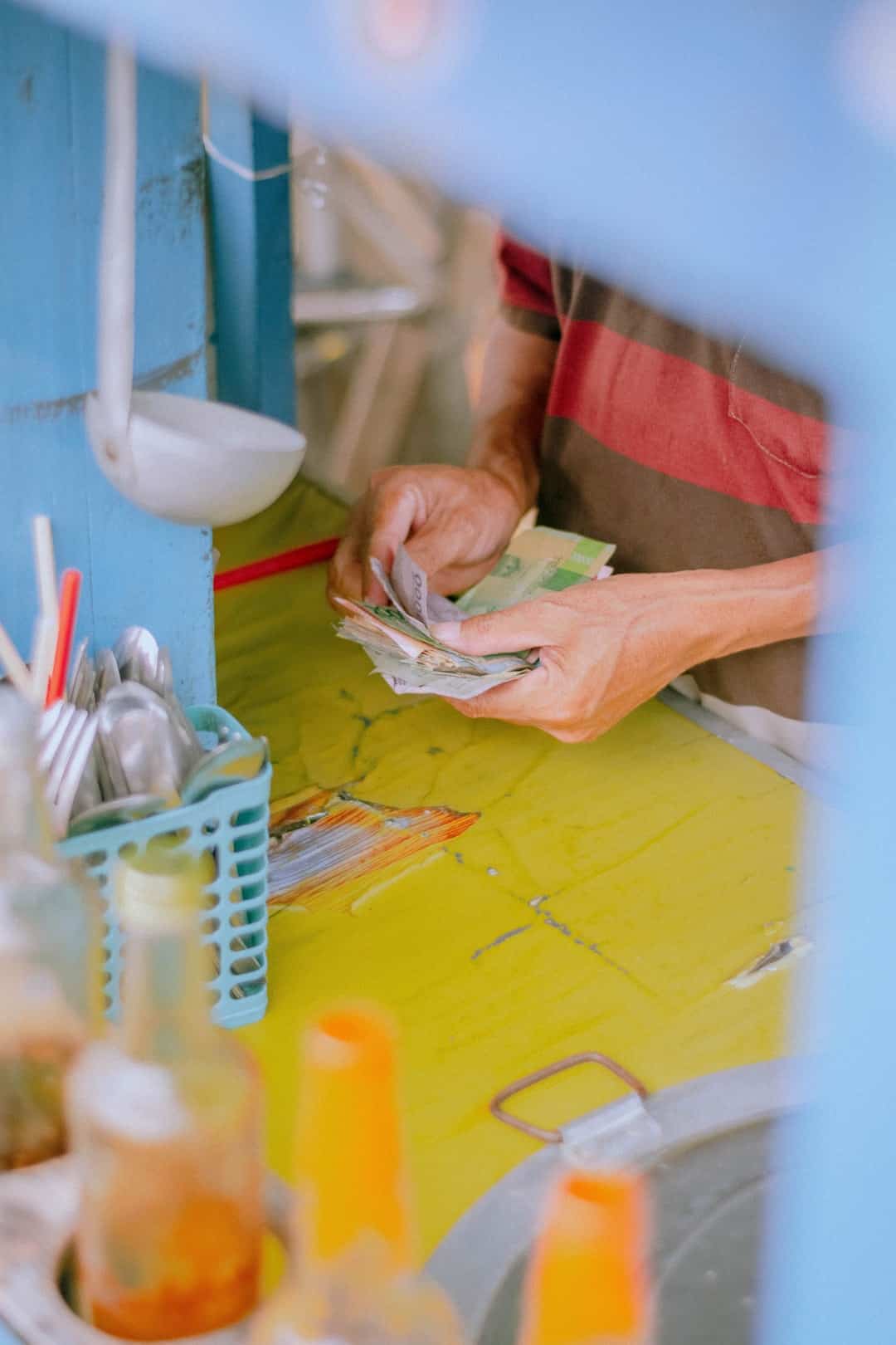 Split image of a thriving business on one side and a flourishing personal savings jar on the other, both built on a foundation of calculators and pie charts